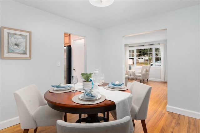 dining area with light hardwood / wood-style floors