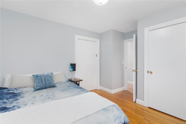 bedroom featuring hardwood / wood-style floors and a closet