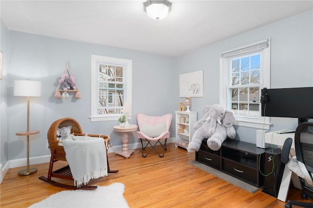 sitting room with a wealth of natural light and light hardwood / wood-style flooring