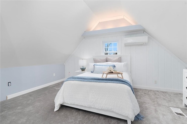 carpeted bedroom with a wall mounted AC and lofted ceiling