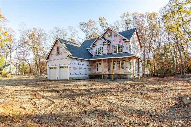 view of front facade featuring a porch and a garage