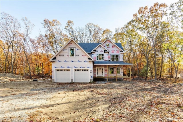 view of front facade featuring a garage and covered porch