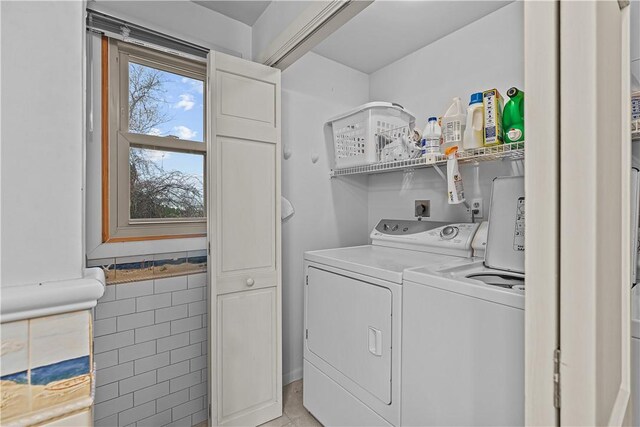 clothes washing area featuring washer and clothes dryer