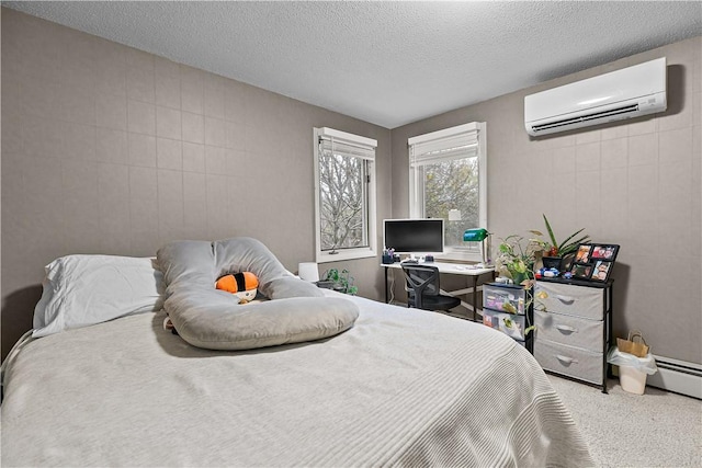 carpeted bedroom with a wall mounted air conditioner and a textured ceiling