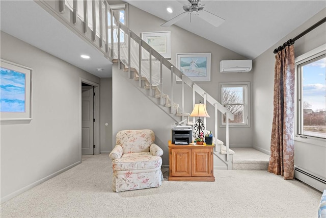 living area with carpet floors, vaulted ceiling, a wall mounted AC, and ceiling fan