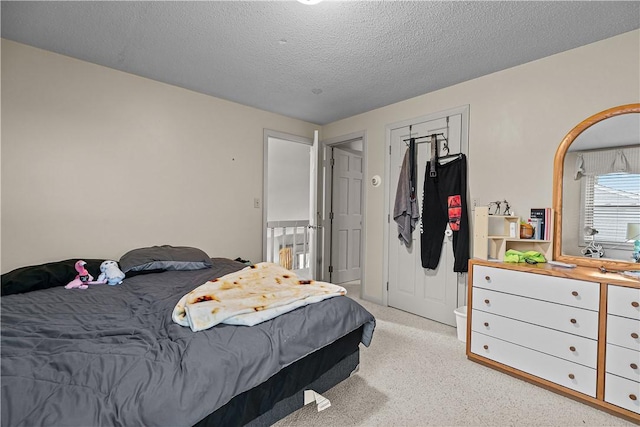 carpeted bedroom featuring a textured ceiling