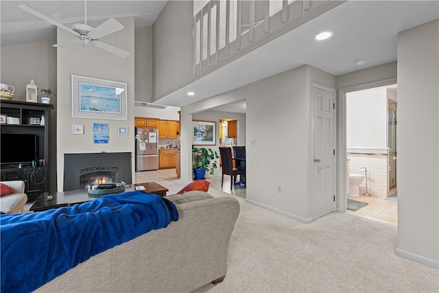 living room featuring light carpet and ceiling fan