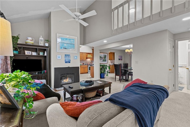 living room featuring light colored carpet, high vaulted ceiling, and ceiling fan