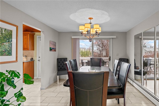 dining area featuring light tile patterned floors, a textured ceiling, an inviting chandelier, and a baseboard heating unit