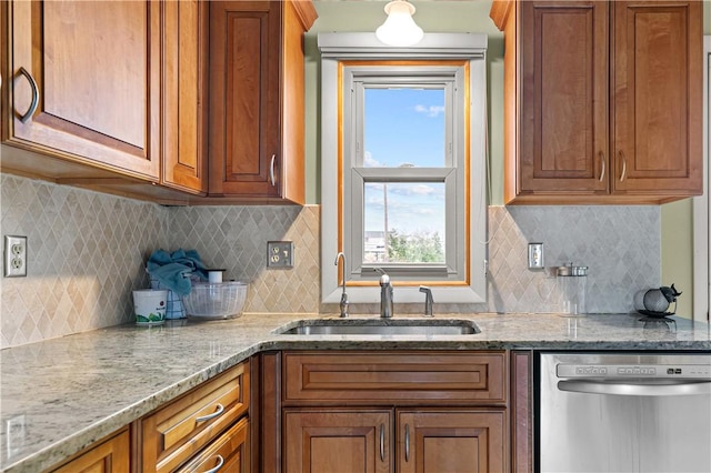 kitchen featuring stainless steel dishwasher, decorative backsplash, light stone countertops, and sink