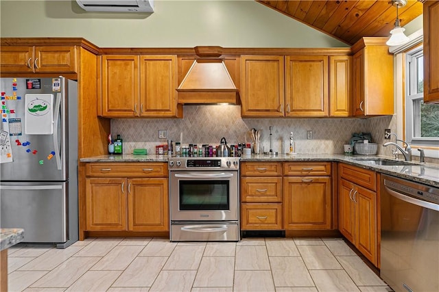 kitchen featuring sink, light stone counters, lofted ceiling, custom range hood, and appliances with stainless steel finishes