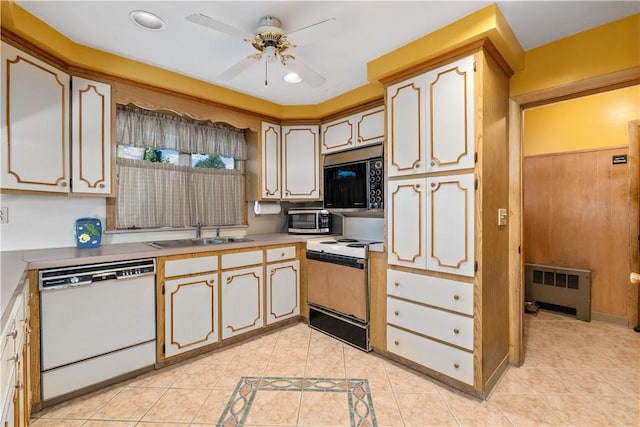 kitchen featuring ceiling fan, sink, radiator heating unit, white appliances, and light tile patterned floors