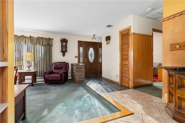 carpeted foyer entrance with a baseboard heating unit