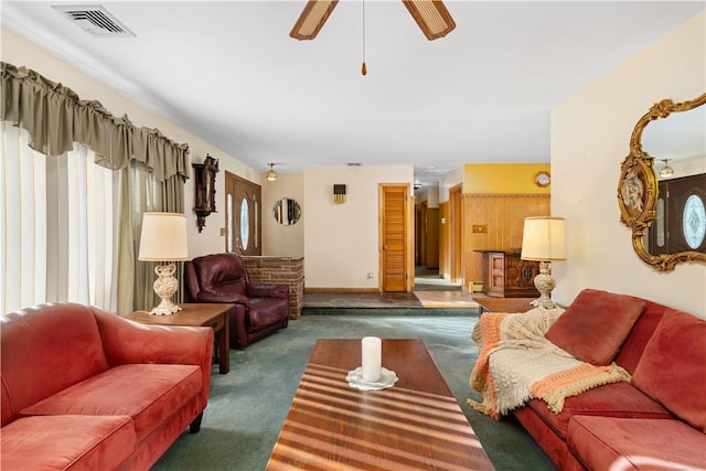 carpeted living room with ceiling fan