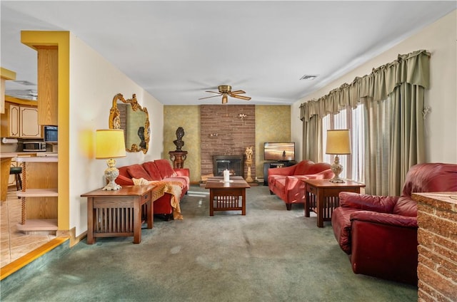 living room featuring carpet flooring, ceiling fan, and a brick fireplace