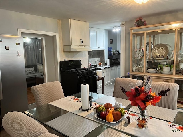 dining area featuring sink and wood-type flooring