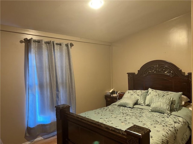 bedroom with hardwood / wood-style floors