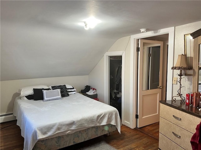 bedroom featuring lofted ceiling, a baseboard radiator, a closet, and dark wood-type flooring