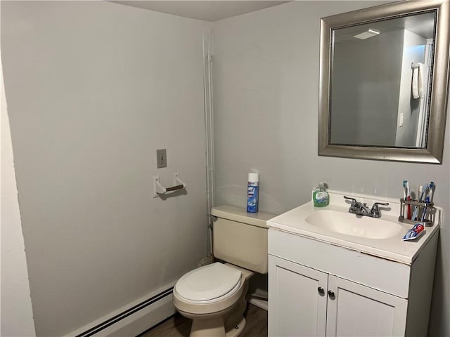 bathroom featuring hardwood / wood-style flooring, vanity, toilet, and baseboard heating