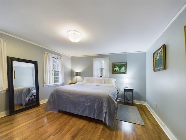 bedroom featuring dark hardwood / wood-style floors and ornamental molding