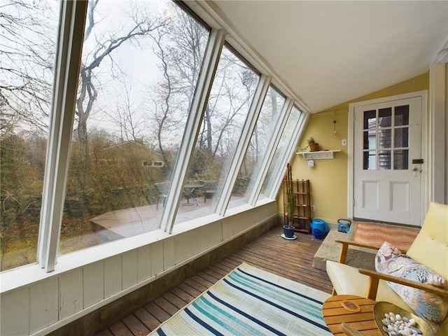 sunroom featuring vaulted ceiling