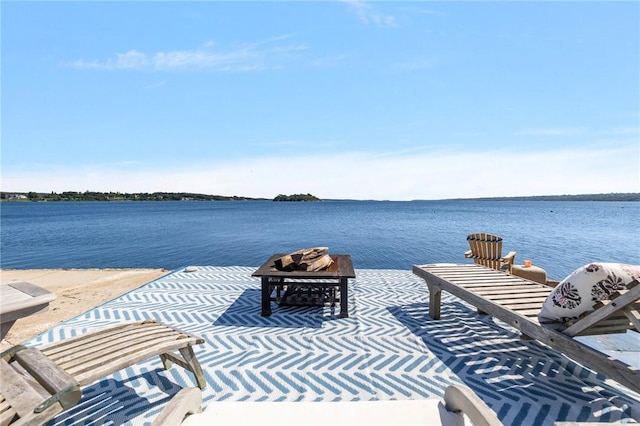 view of patio / terrace with a water view and a fire pit