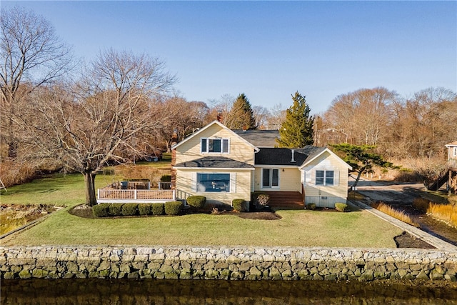 rear view of property with a yard