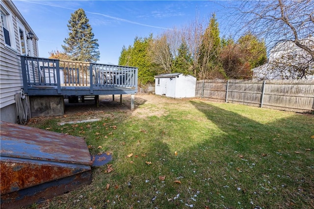 view of yard with a storage shed and a deck