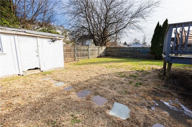 view of yard with a storage unit and a wooden deck