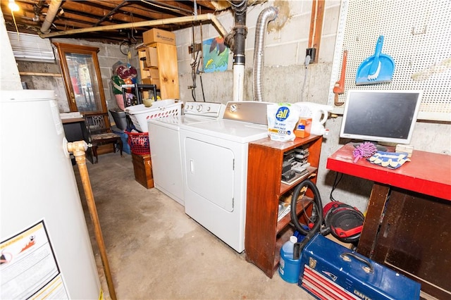 clothes washing area featuring washing machine and dryer and gas water heater