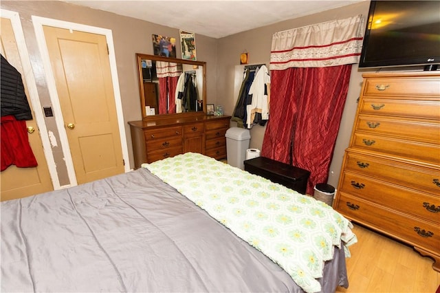 bedroom featuring hardwood / wood-style flooring and a closet