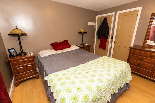 bedroom featuring light hardwood / wood-style floors and a closet