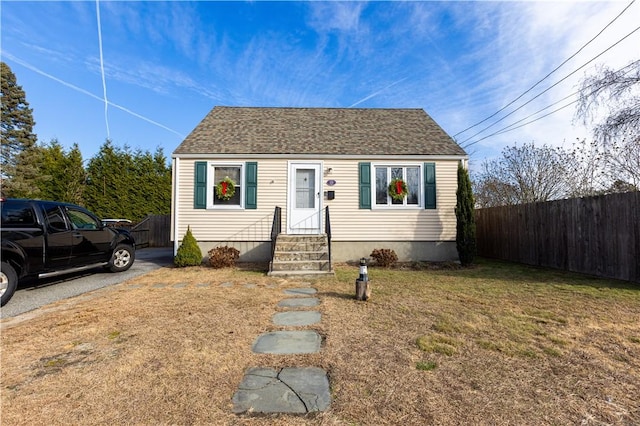 bungalow-style home with a front lawn