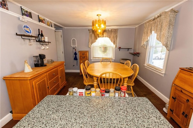 dining room with dark hardwood / wood-style floors, crown molding, and an inviting chandelier