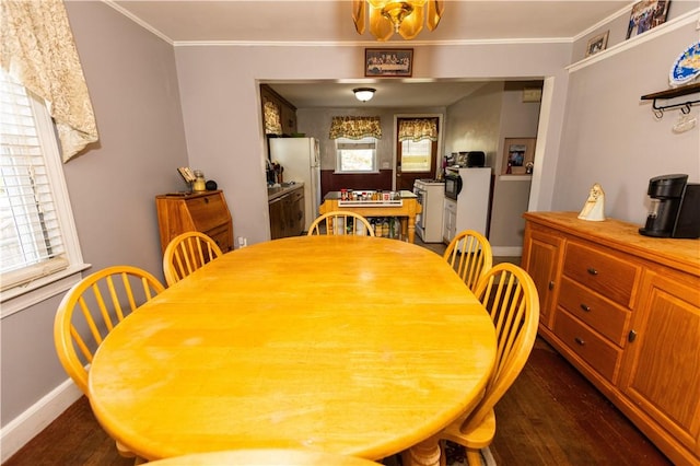 dining room with dark wood-type flooring, a notable chandelier, and ornamental molding