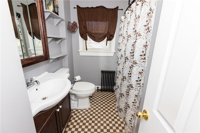 bathroom with radiator heating unit, vanity, a shower with shower curtain, and toilet