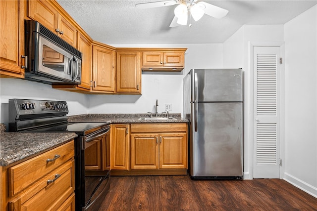 kitchen with ceiling fan, sink, stainless steel appliances, and dark hardwood / wood-style floors