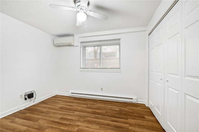 unfurnished bedroom featuring a wall mounted AC, ceiling fan, dark hardwood / wood-style flooring, and a baseboard heating unit