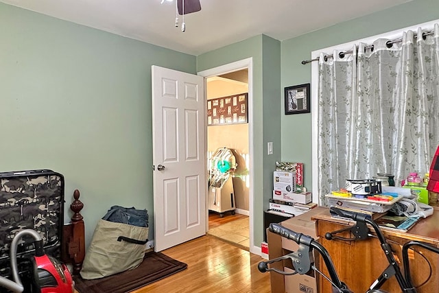 home office featuring ceiling fan and light hardwood / wood-style floors