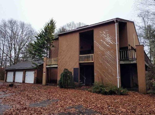 exterior space featuring a balcony and a garage