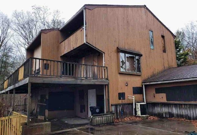 back of property featuring a balcony