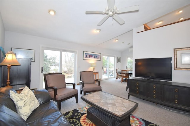 living room featuring carpet flooring, ceiling fan, lofted ceiling, and a wealth of natural light