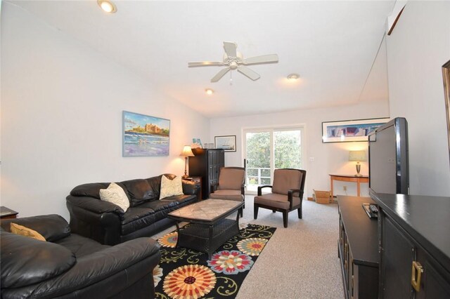 carpeted living room with vaulted ceiling and ceiling fan