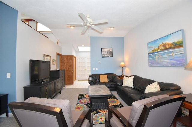 carpeted living room with ceiling fan and lofted ceiling