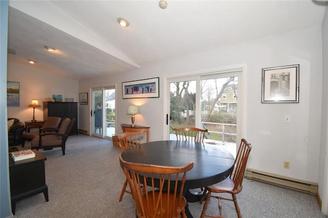 dining room with carpet flooring, a baseboard radiator, and lofted ceiling