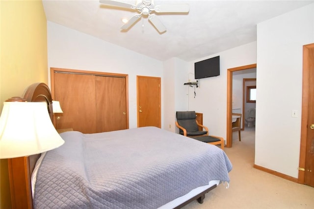 bedroom featuring light carpet, two closets, ceiling fan, and lofted ceiling