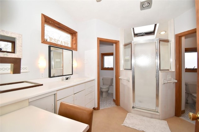 bathroom with tile patterned flooring, vanity, toilet, and a shower with door