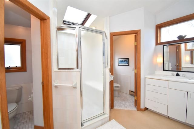 bathroom featuring plenty of natural light, tile walls, and toilet