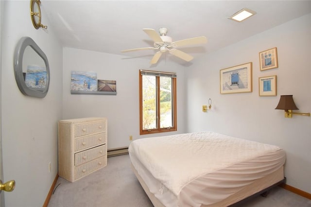 bedroom with ceiling fan, light colored carpet, and a baseboard heating unit