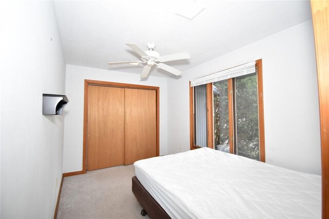 carpeted bedroom featuring a closet and ceiling fan